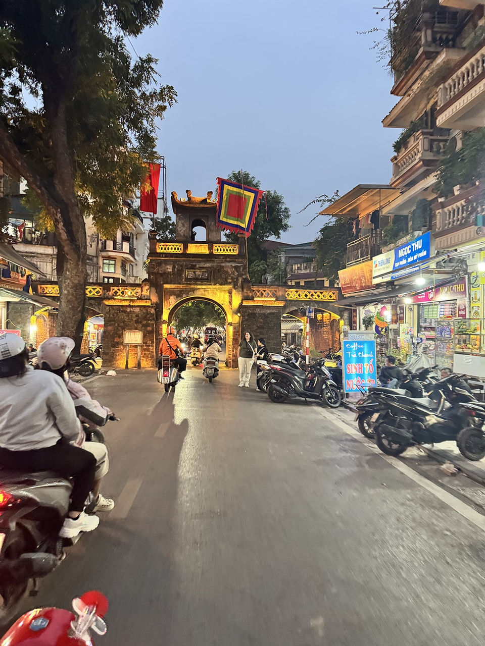 Travelers riding Vespa scooters