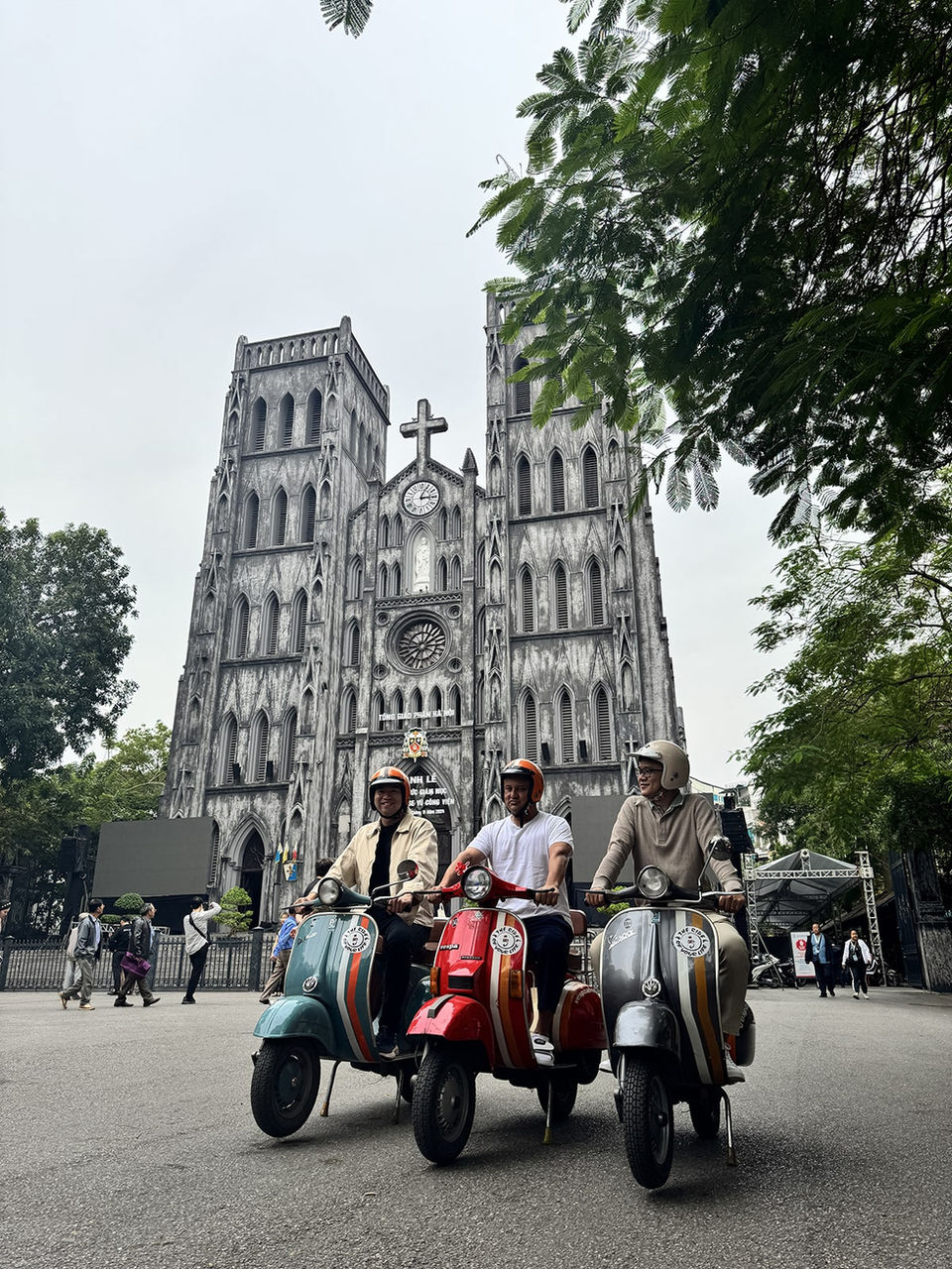 Travelers on Vespa tour at Notre Dame Saigon