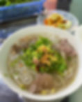 A bowl of phở from Hoi An with a fragrant broth and fresh seafood